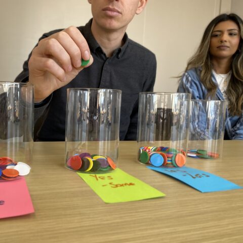 Image shows counters being placed into jars