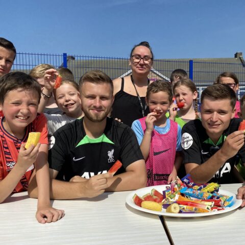 Image shows children enjoying fruit as part of a Feast of Fun activity